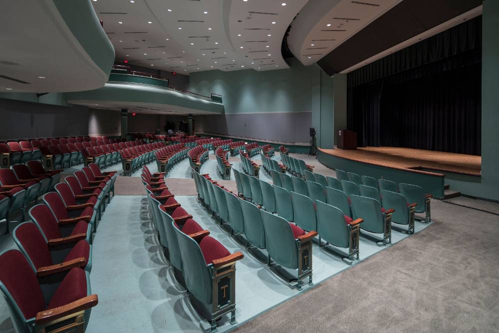 Auditorium with ramp seating, staging, and a presentation podium