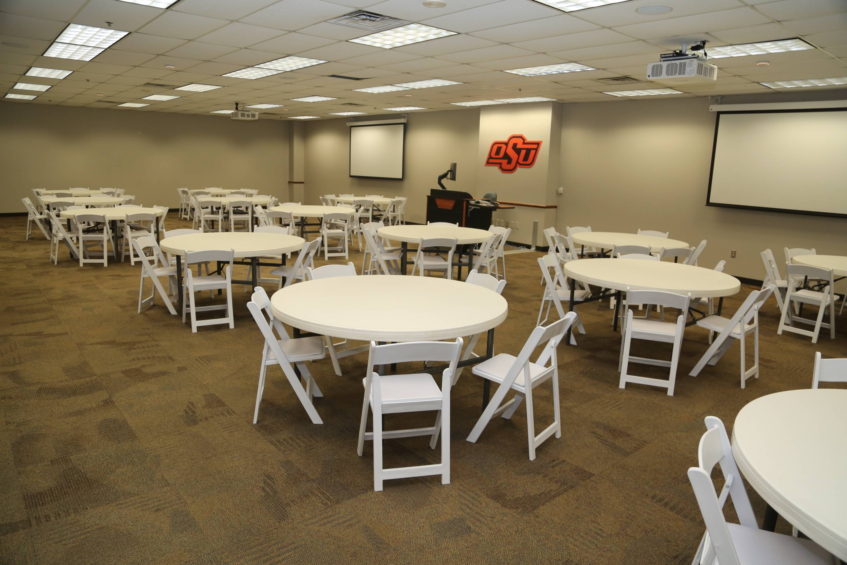 B.S. Roberts room set up with empty round tables and white folding chairs