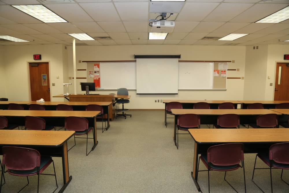 Standard classroom with long tables and 3 chairs per table