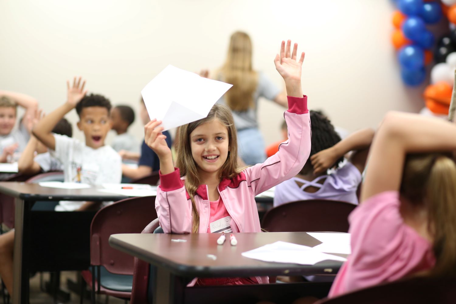 STEM Camp student raises her hand