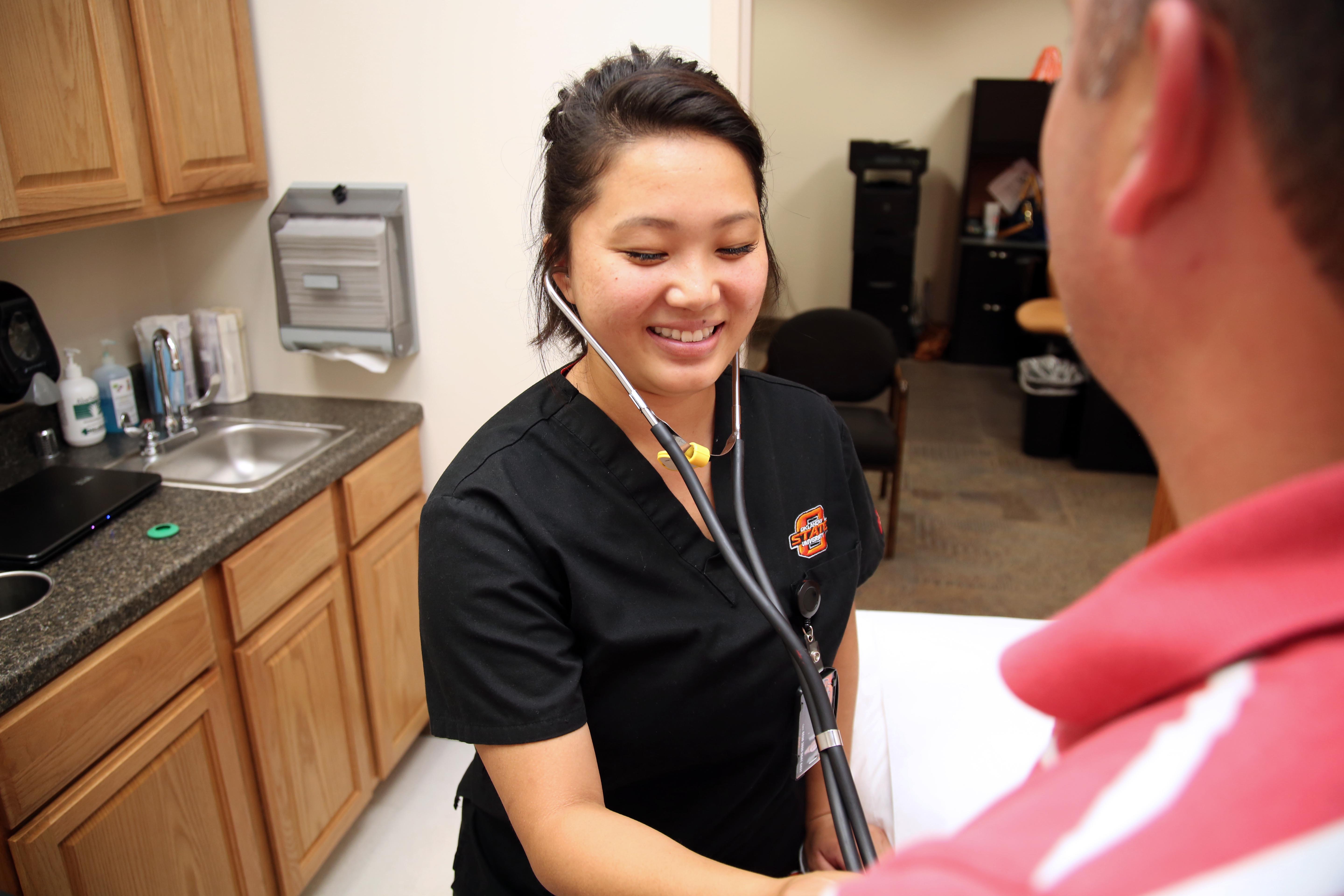 Female nurse takes male patient's blood pressure