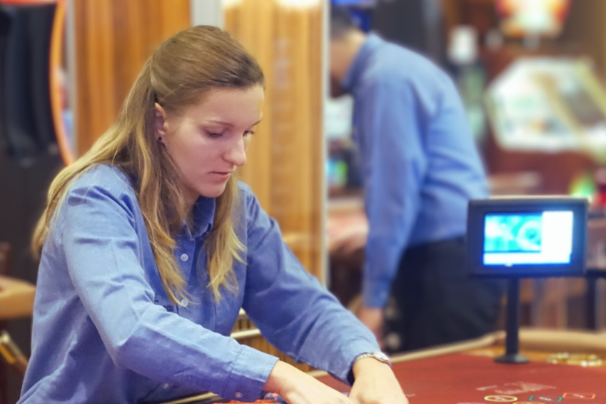 Woman deals cards at casino table