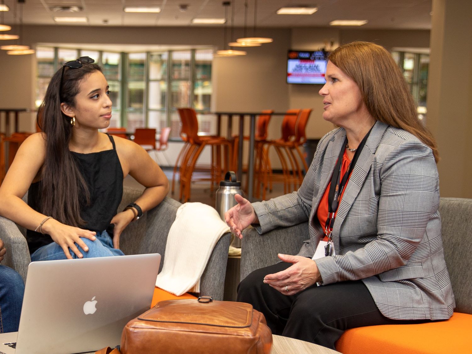 Two colleagues having a discussion in a lounge