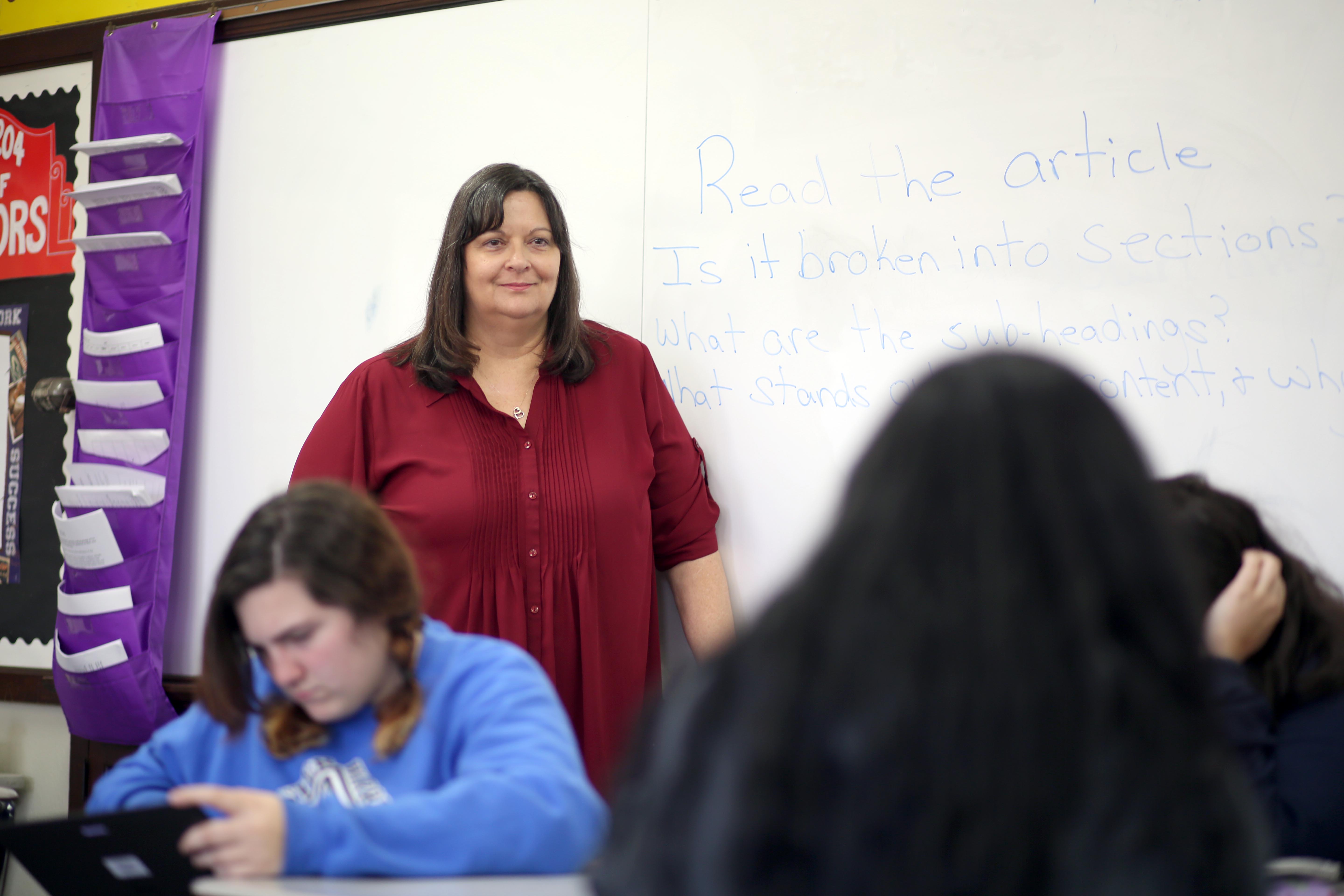 Woman teaching in a classroom of children