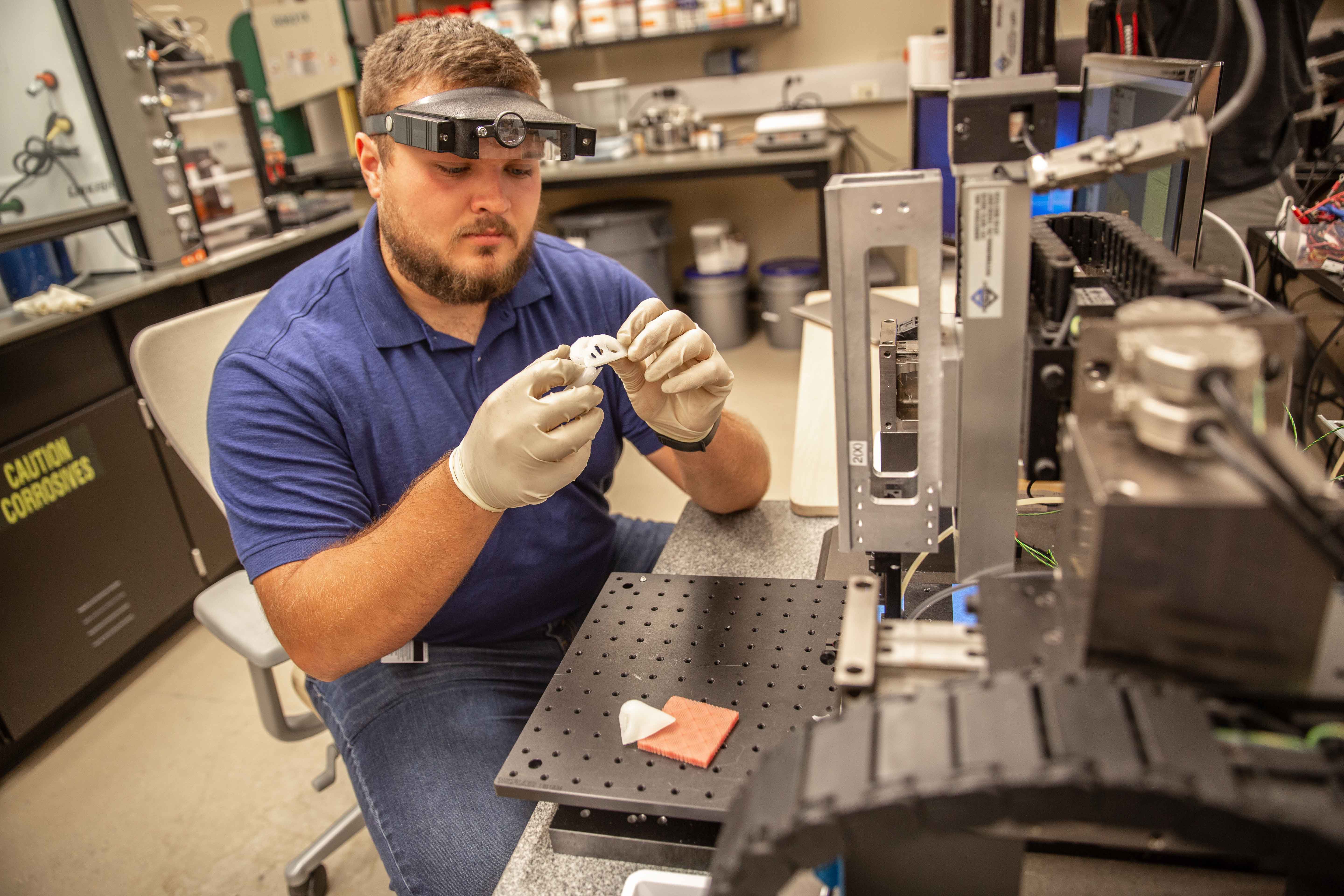 Man examining materials in Helmerich Research Center.