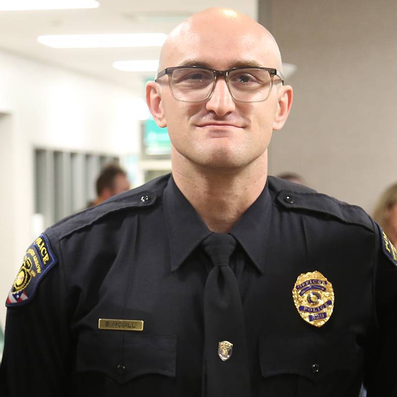 Broken Arrow Police Department Office Brandon McGill standing in front of police training sign