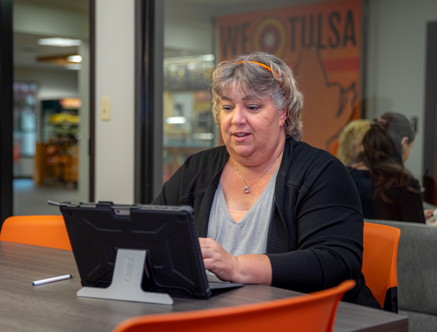 two women in an office review files