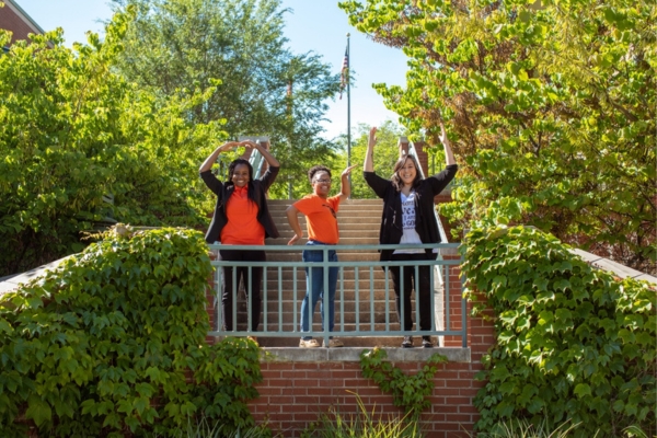 Students make O-S-U letters at the courtyard fountain